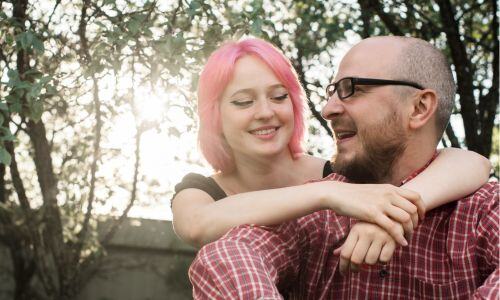 Girl with pink hair and carer